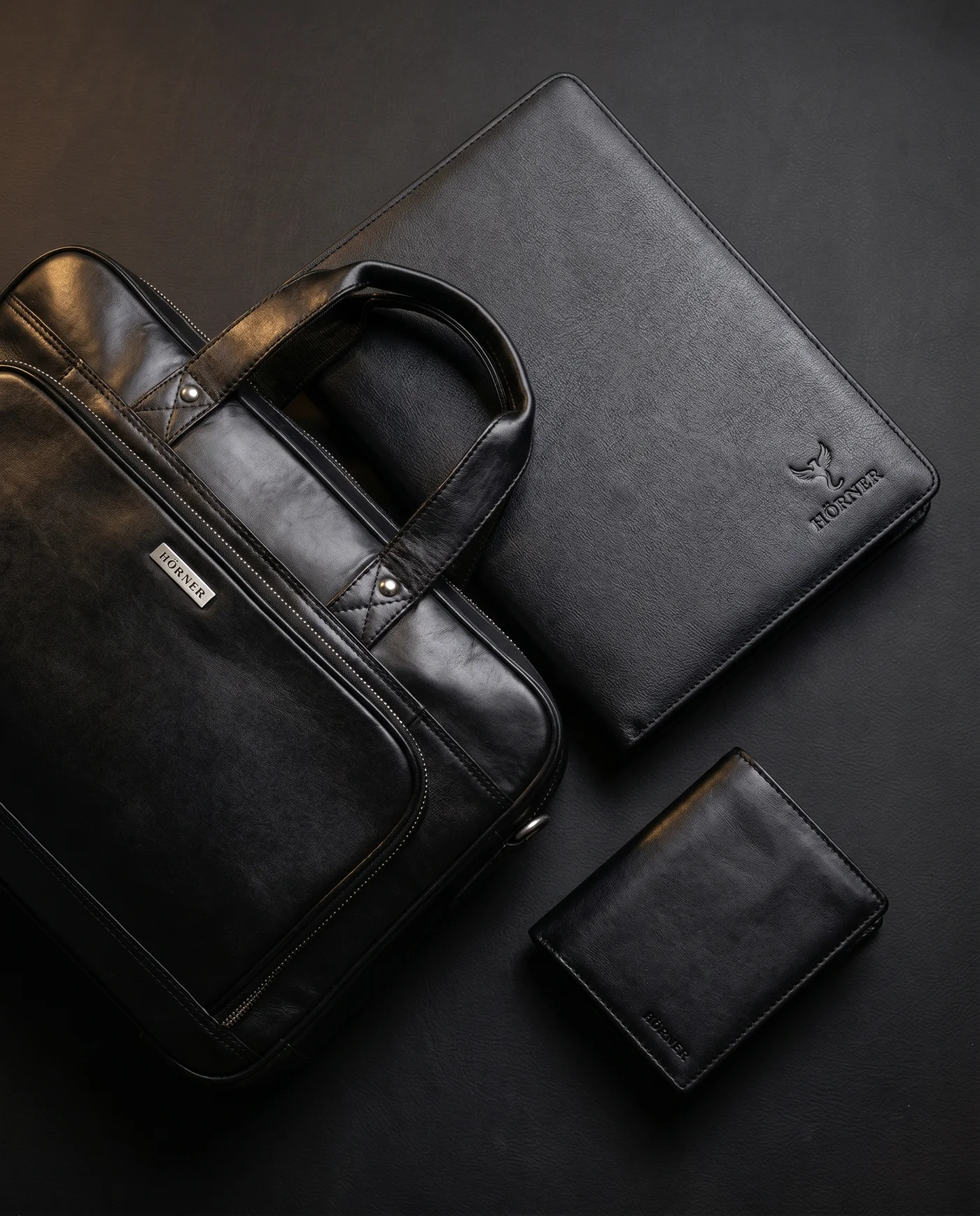 Familia de artículos de cuero Hörner: maletín para portátil, portadocumentos y cartera en negro