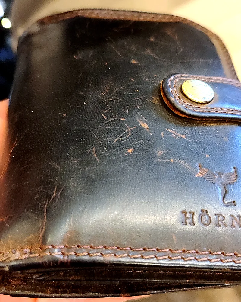 Detalle de la cartera Fortis con finas marcas de abrasión sobre la superficie de cuero